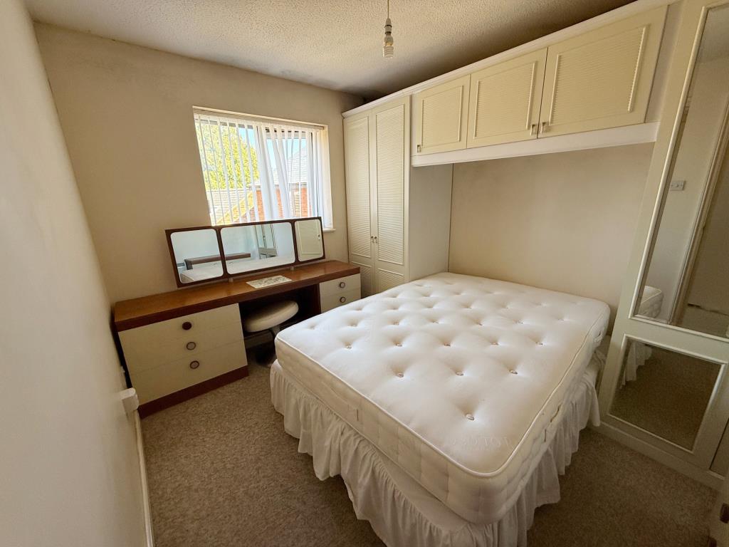 Lot: 32 - ONE-BEDROOM FLAT IN NEED OF IMPROVEMENT - Bedroom with fitted wardrobes around bed space